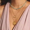 Protected by the goddess moon, we are free to transform into our most authentic selves. An 18kt gold plated necklace is adorned with a lotus flower, a crescent moon, and a white topaz star, inspiring new beginnings, offering protection and goddess energy,