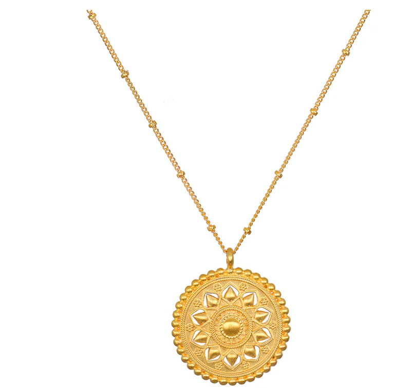 This is an invitation to journey home to yourself, to tend to the brilliance of your inner light. An 18kt gold plate necklace gleams with an intricate mandala pendant. Designed to reflect the multi-layered petals of the lotus flower, a symbol of new begin